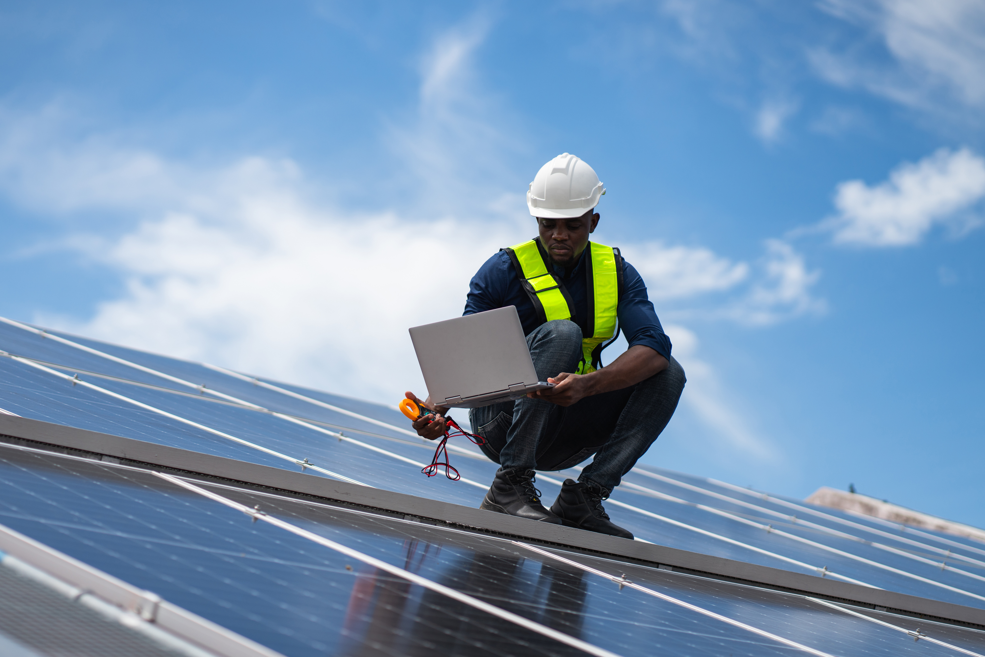 Service engineer checking solar cell on the roof for maintenance if there is a damaged part. Engineer worker install solar panel. Clean energy concept.